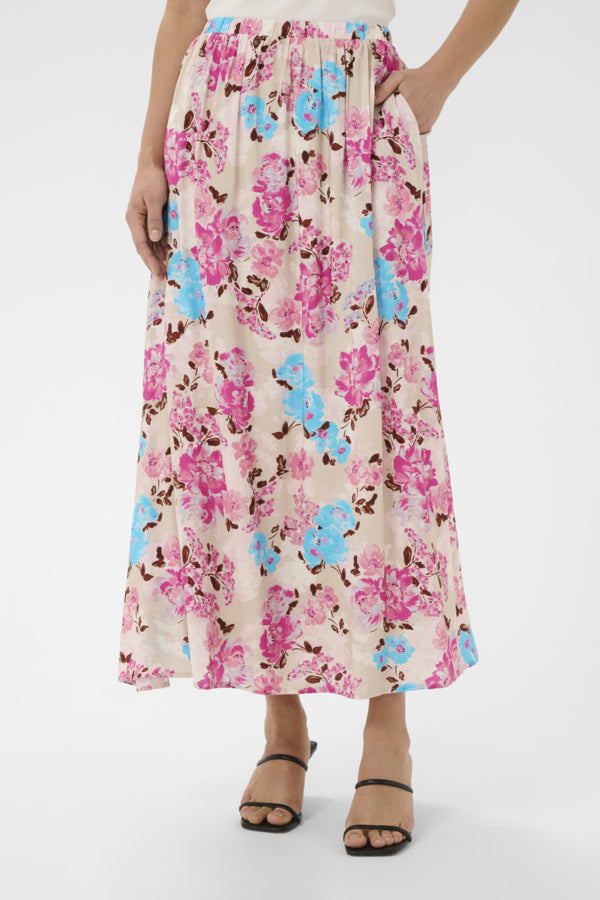 Floral patterned skirt worn by a person on a white background