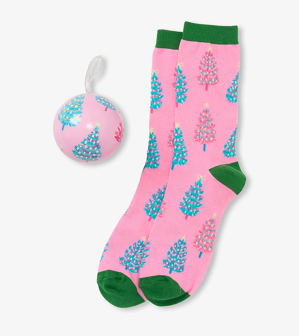 Pink socks with blue floral patterns and green accents, paired with a matching pink ball on a white background.