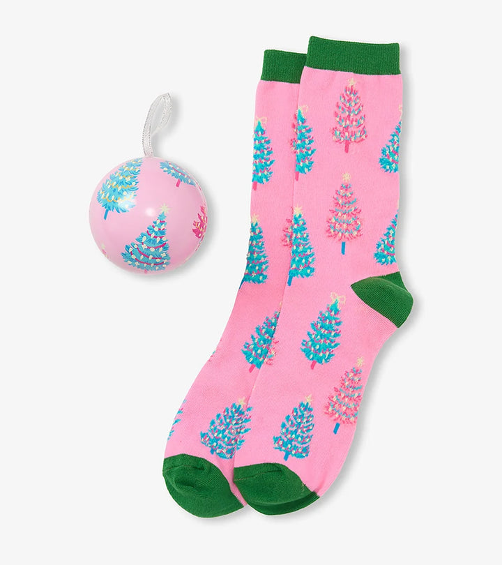 Pink socks with blue floral patterns and green accents, paired with a matching pink ball on a white background.