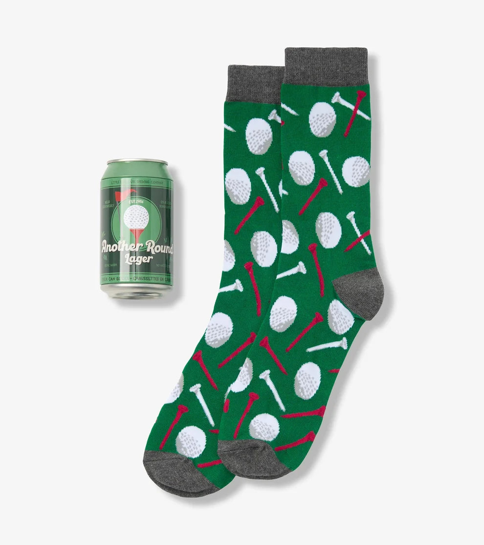 Green socks with golf ball and club pattern next to a can of beer on a white background
