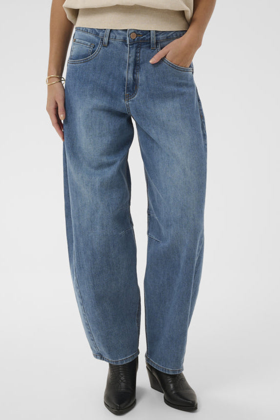 Person wearing blue jeans on a white background