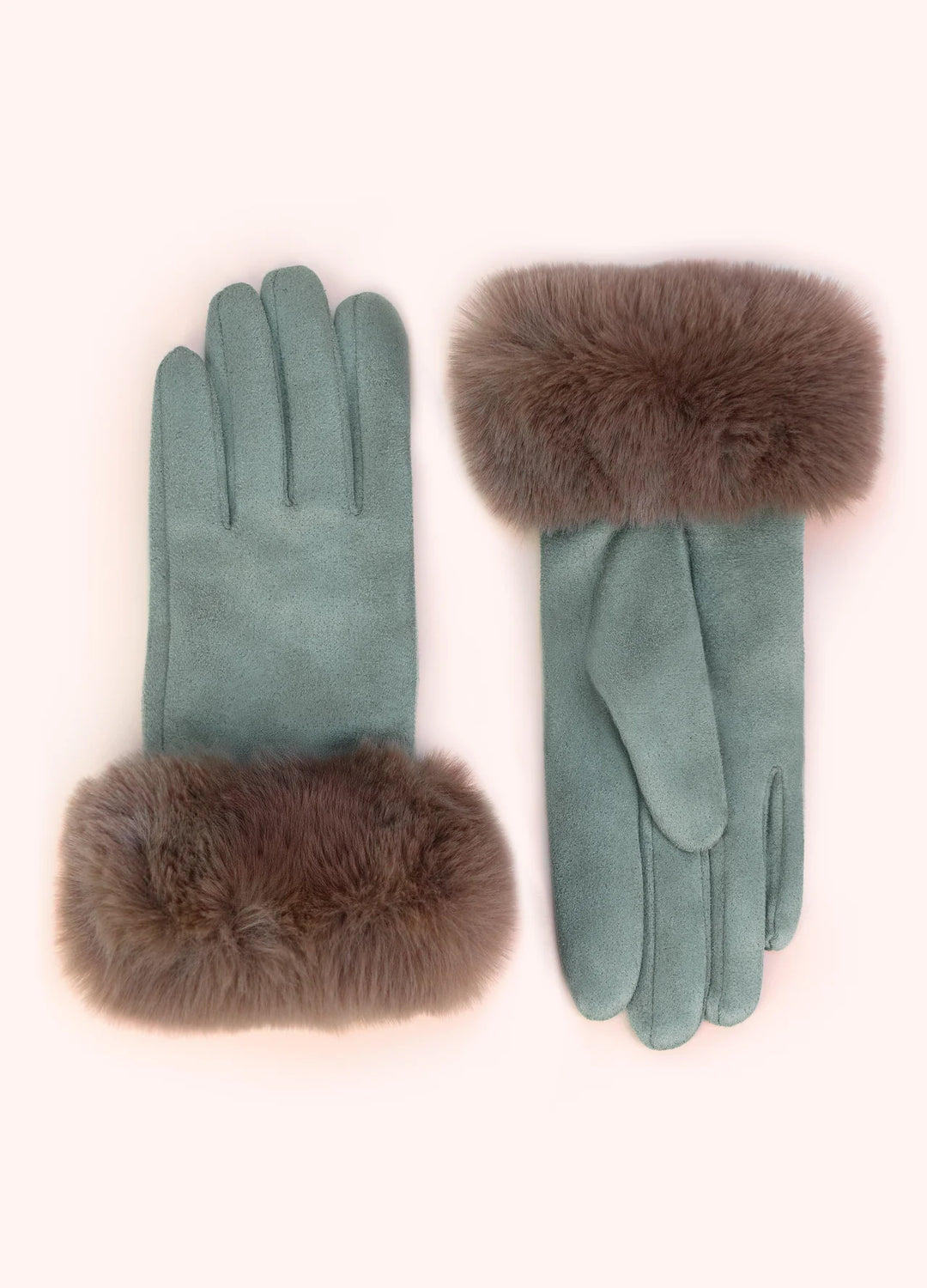 A pair of sage green suede gloves with brown fur cuffs, displayed flat against a pale pink background.