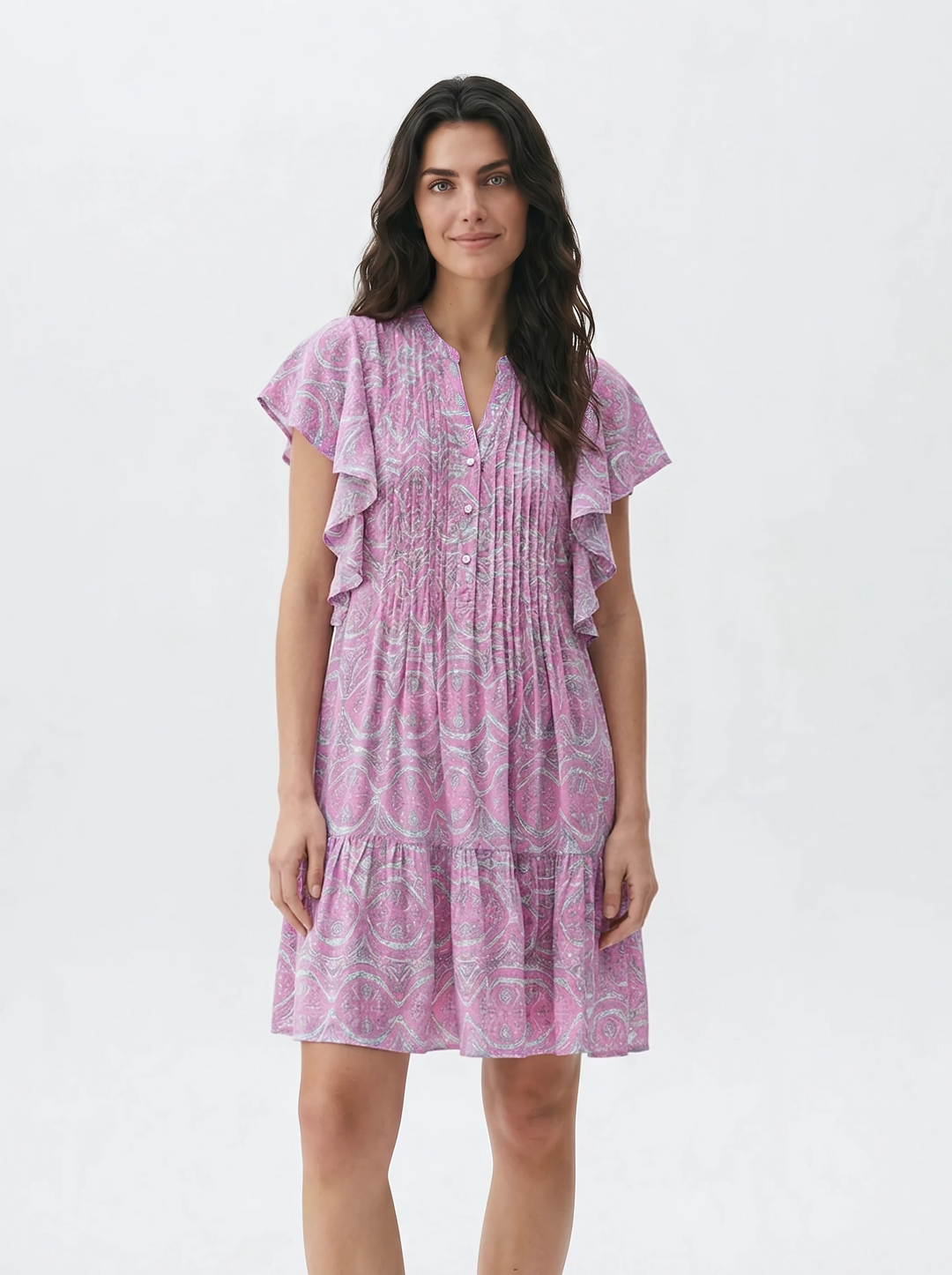Woman wearing a pink patterned dress on a white background