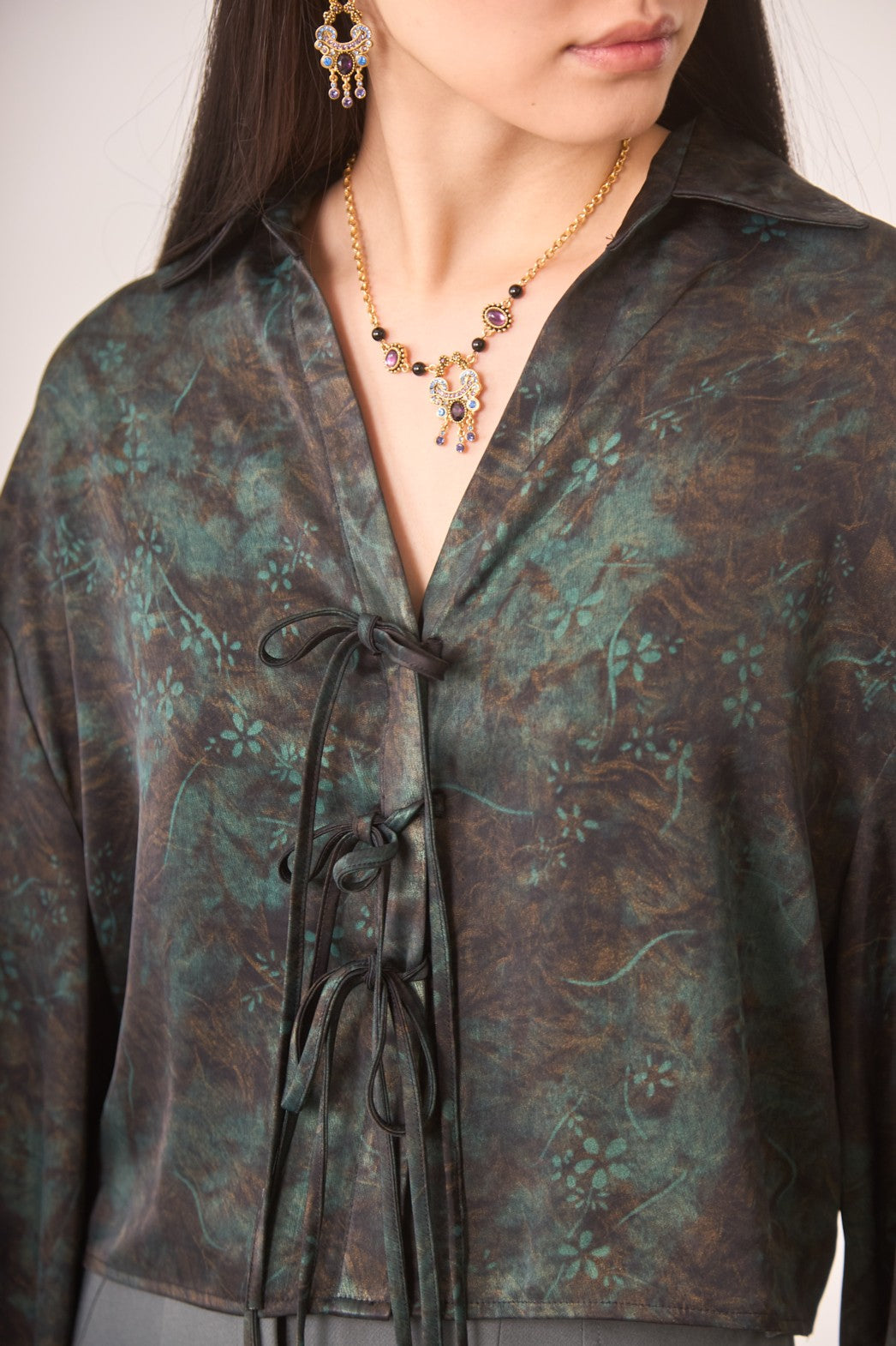 Close-up of a person wearing a Bows Cropped Blouse 