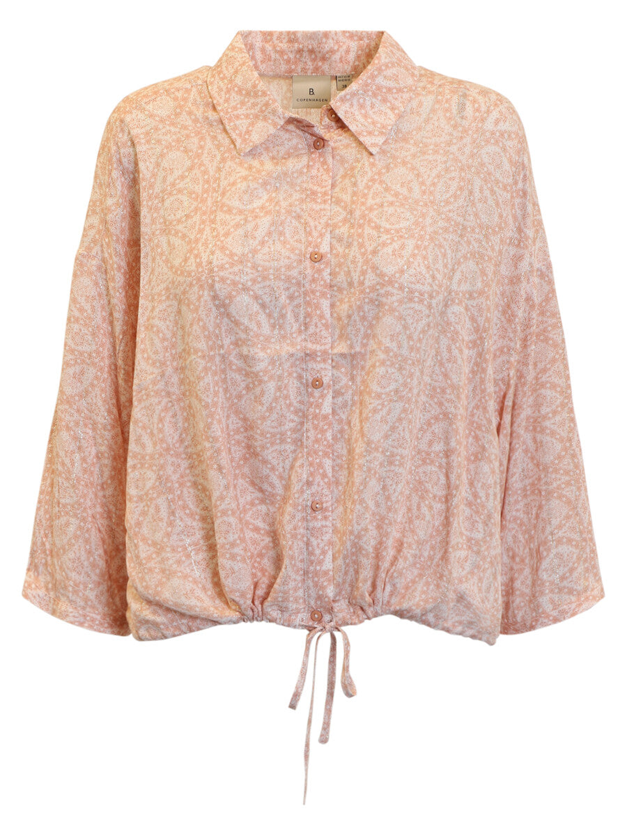 Pink floral blouse with long sleeves on a white background