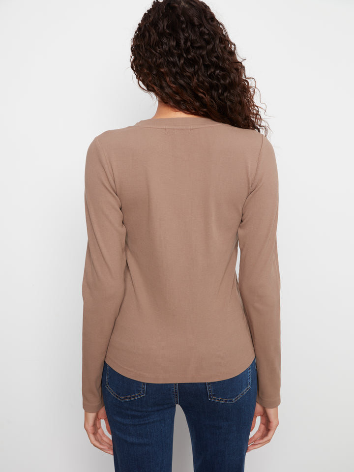 Person wearing a brown long-sleeve shirt and blue jeans on a white background