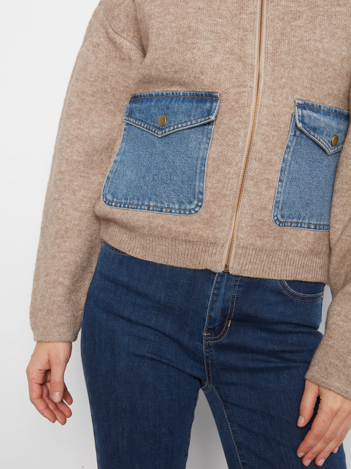 Beige sweater with denim pocket design on a white background