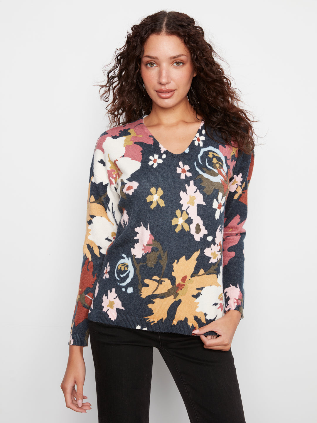 Woman wearing a floral sweater on a white background
