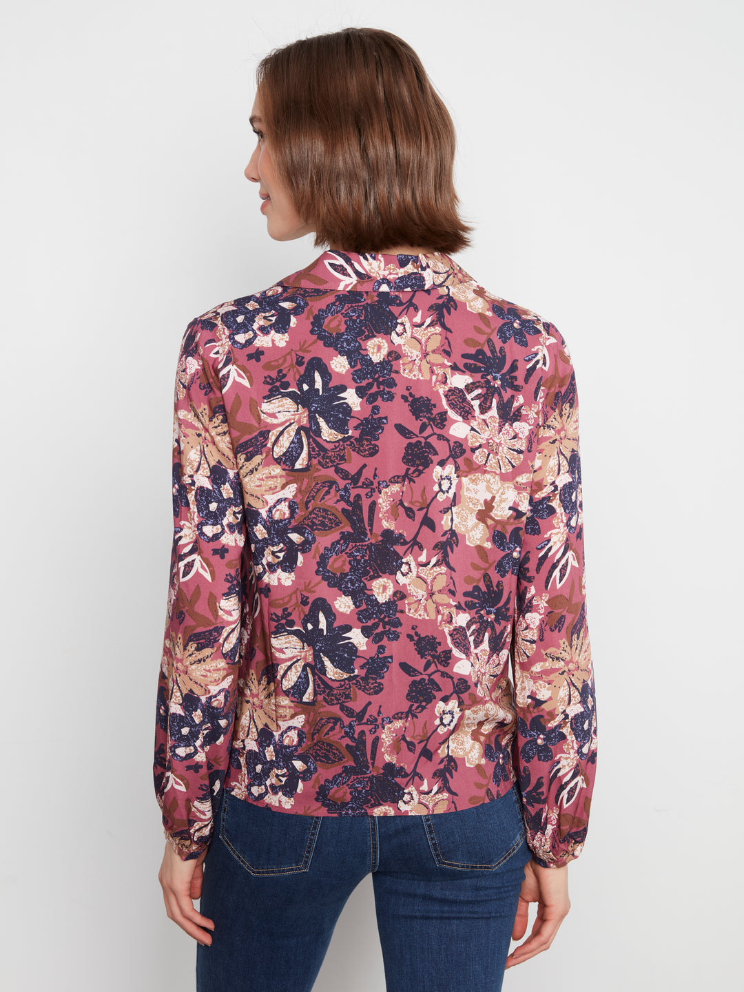 Woman wearing a floral blouse with a white background