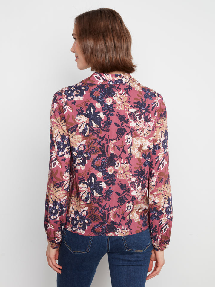 Woman wearing a floral blouse with a white background