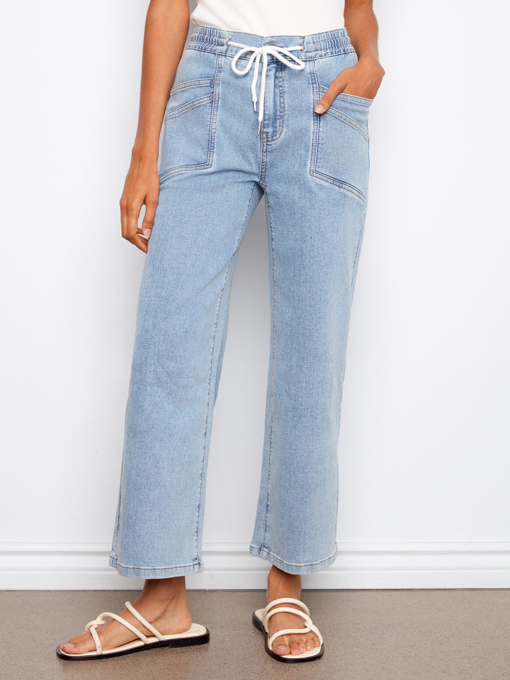 Light blue jeans worn by a person on a white background