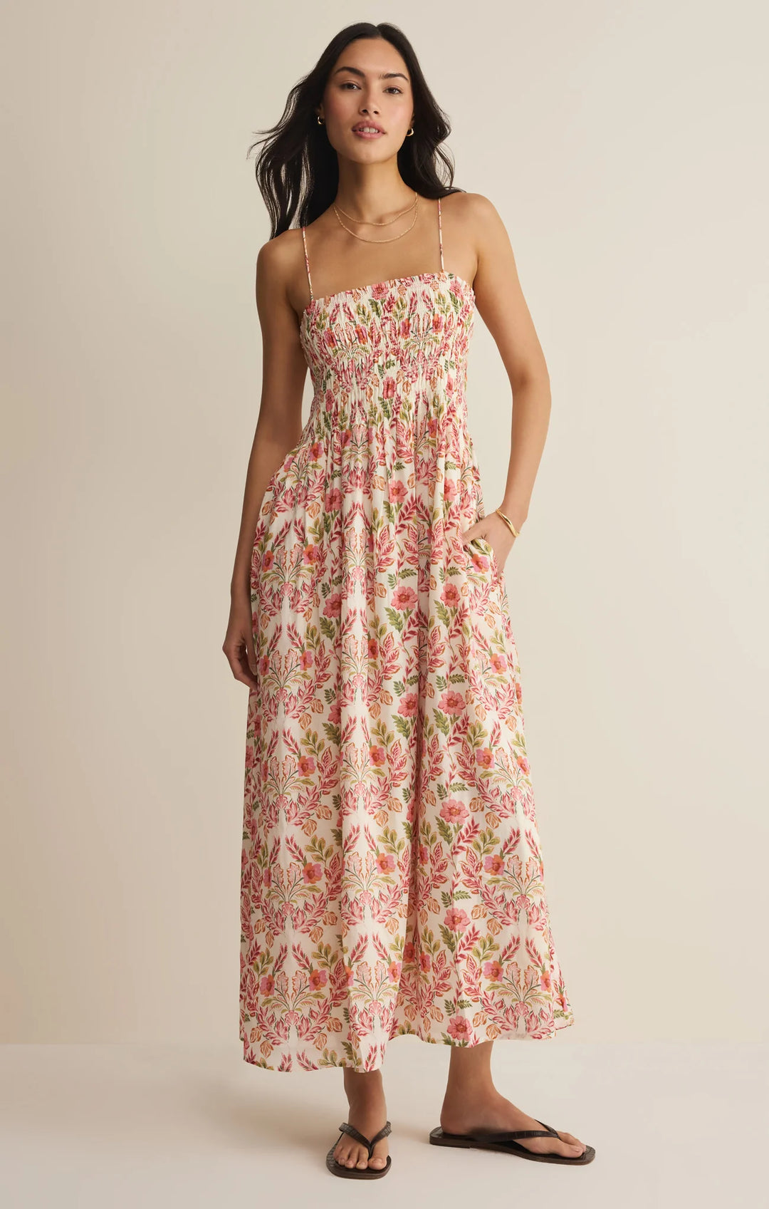 Woman wearing a floral dress against a beige background