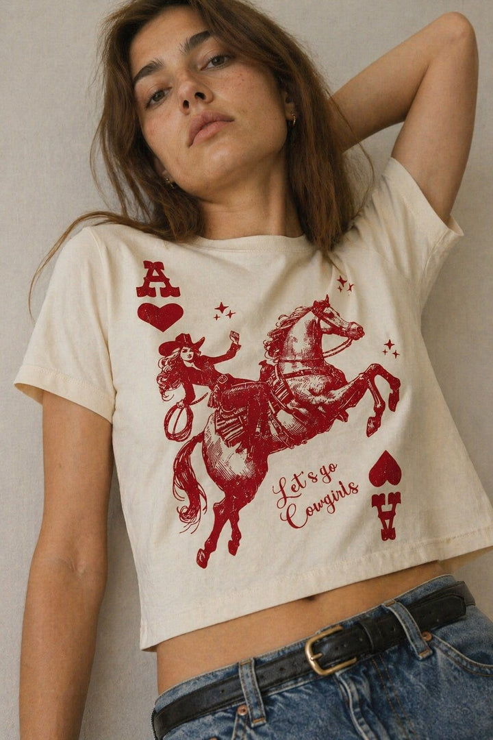 Woman wearing a white t-shirt with a red graphic design and text.