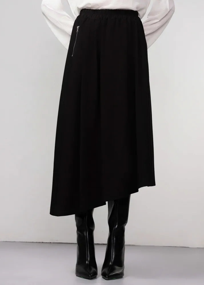 Black skirt worn by a person on a white background