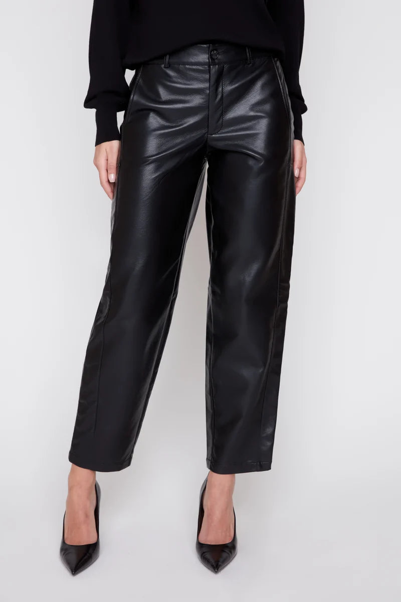 Person wearing black leather pants on a white background