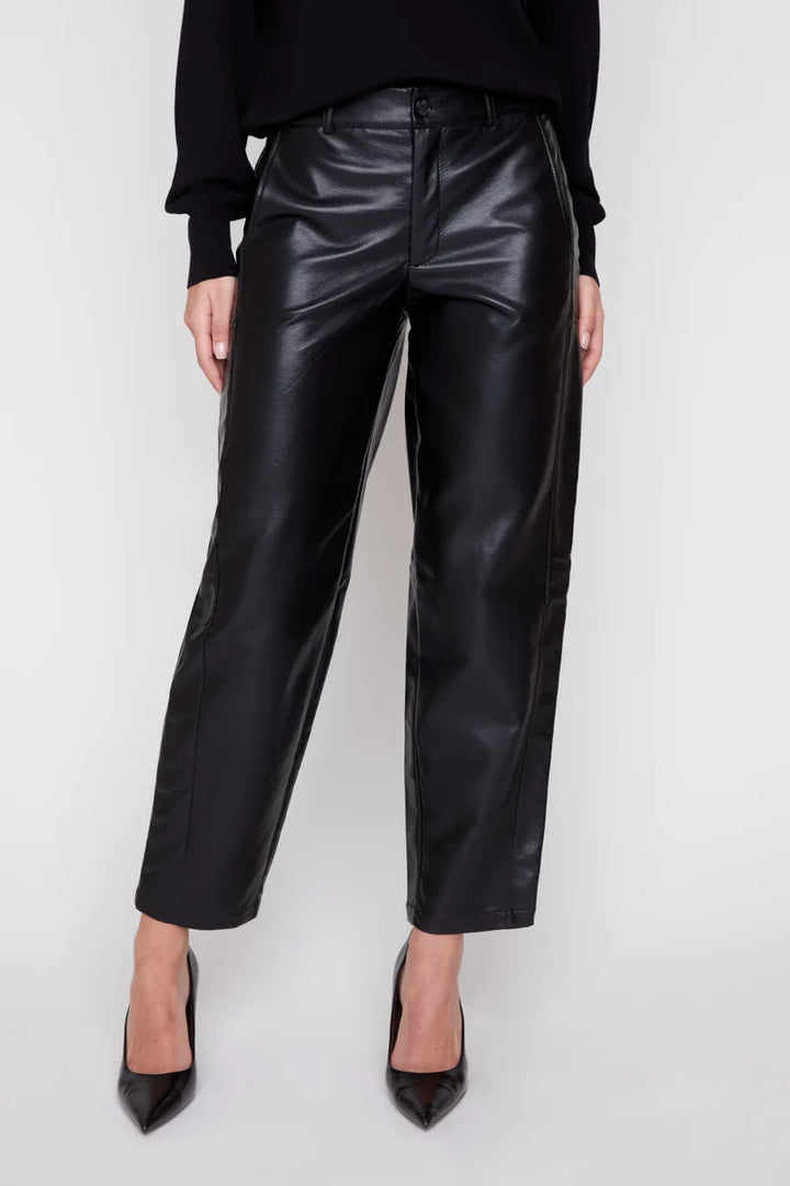 Person wearing black leather pants on a white background
