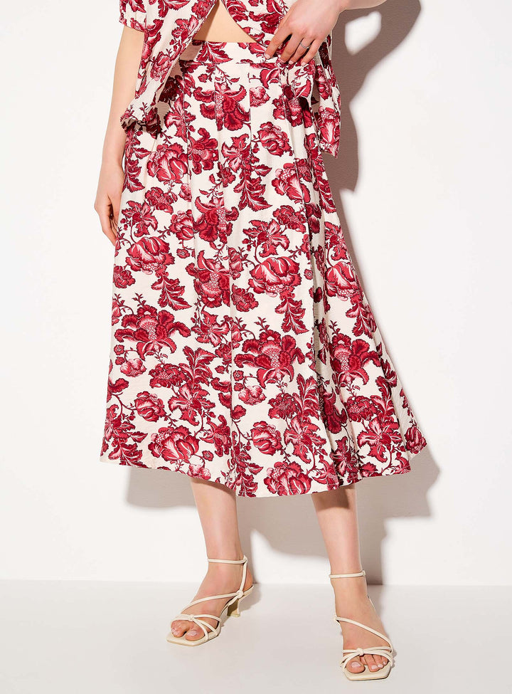 Person wearing a red floral dress on a white background