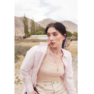 Woman standing outdoors with mountains in the background
