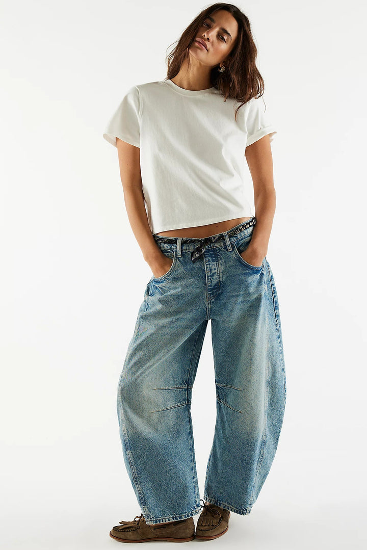 Person wearing a white t-shirt and blue jeans on a white background