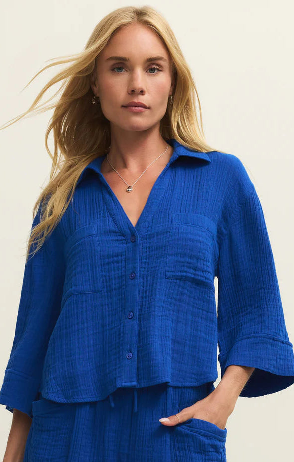 Woman wearing a blue outfit with a plain background