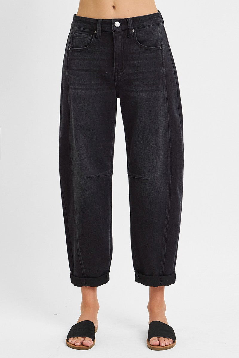 Black jeans worn by a person on a white background