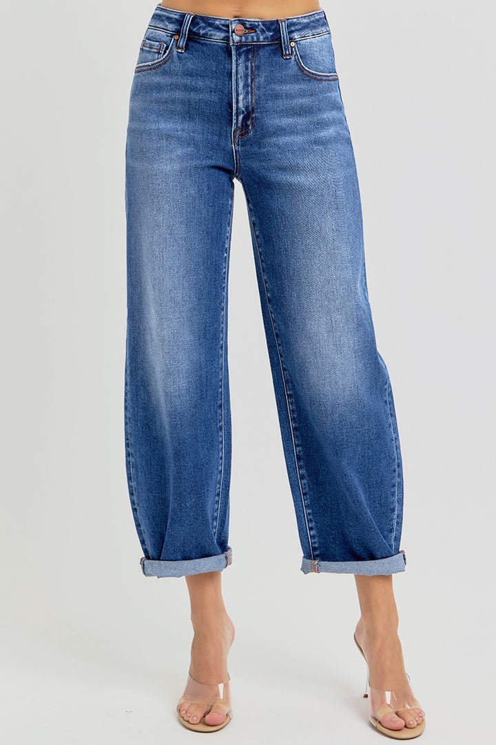Blue jeans worn by a person on a light gray background