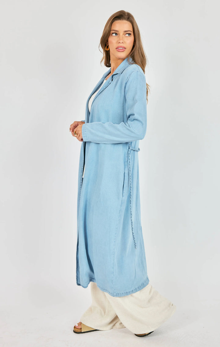 Woman wearing a light blue robe on a white background