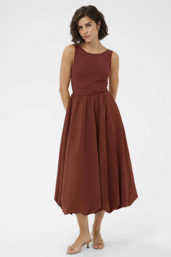 Woman wearing a brown dress on a white background
