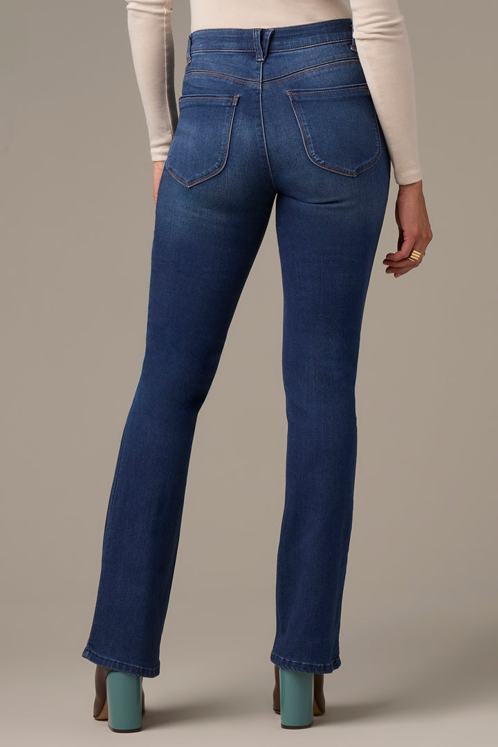 Blue jeans worn by a person on a neutral background