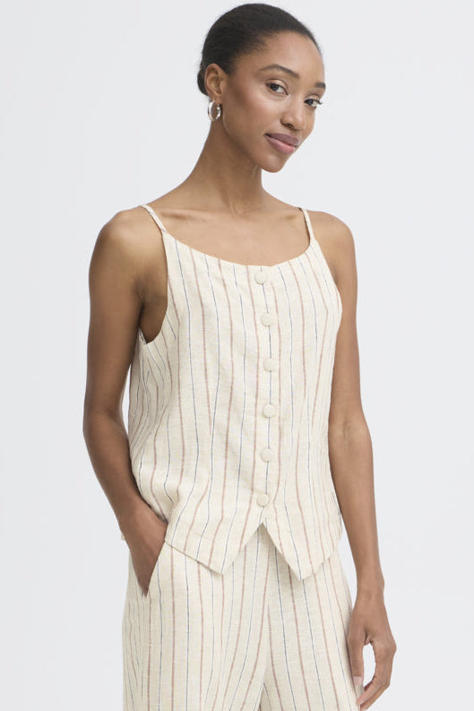 Woman wearing a white pinstripe dress against a plain background