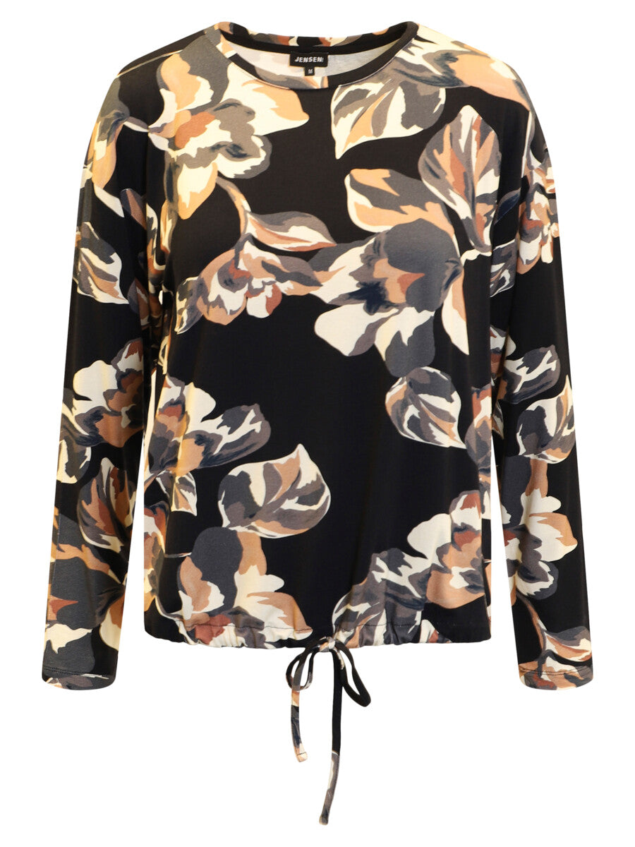 A long-sleeve blouse with a black base and a large floral print in beige, brown, and gray, featuring a drawstring hem.