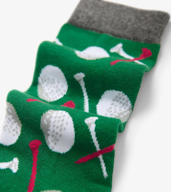 Green socks with golf ball and club pattern on a white background