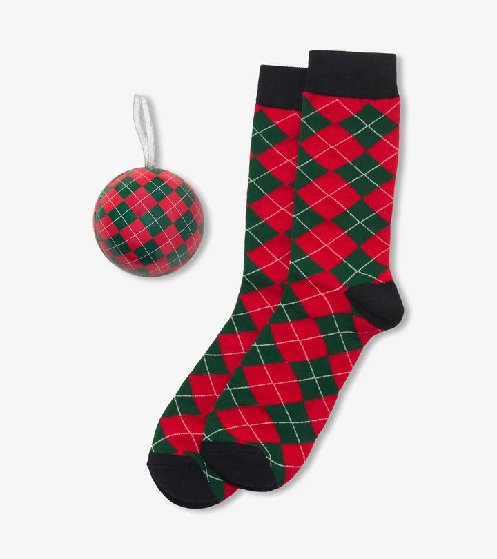 A pair of red and green argyle socks with black cuffs, heels, and toes, shown alongside a matching red and green argyle Christmas ornament on a light gray background.