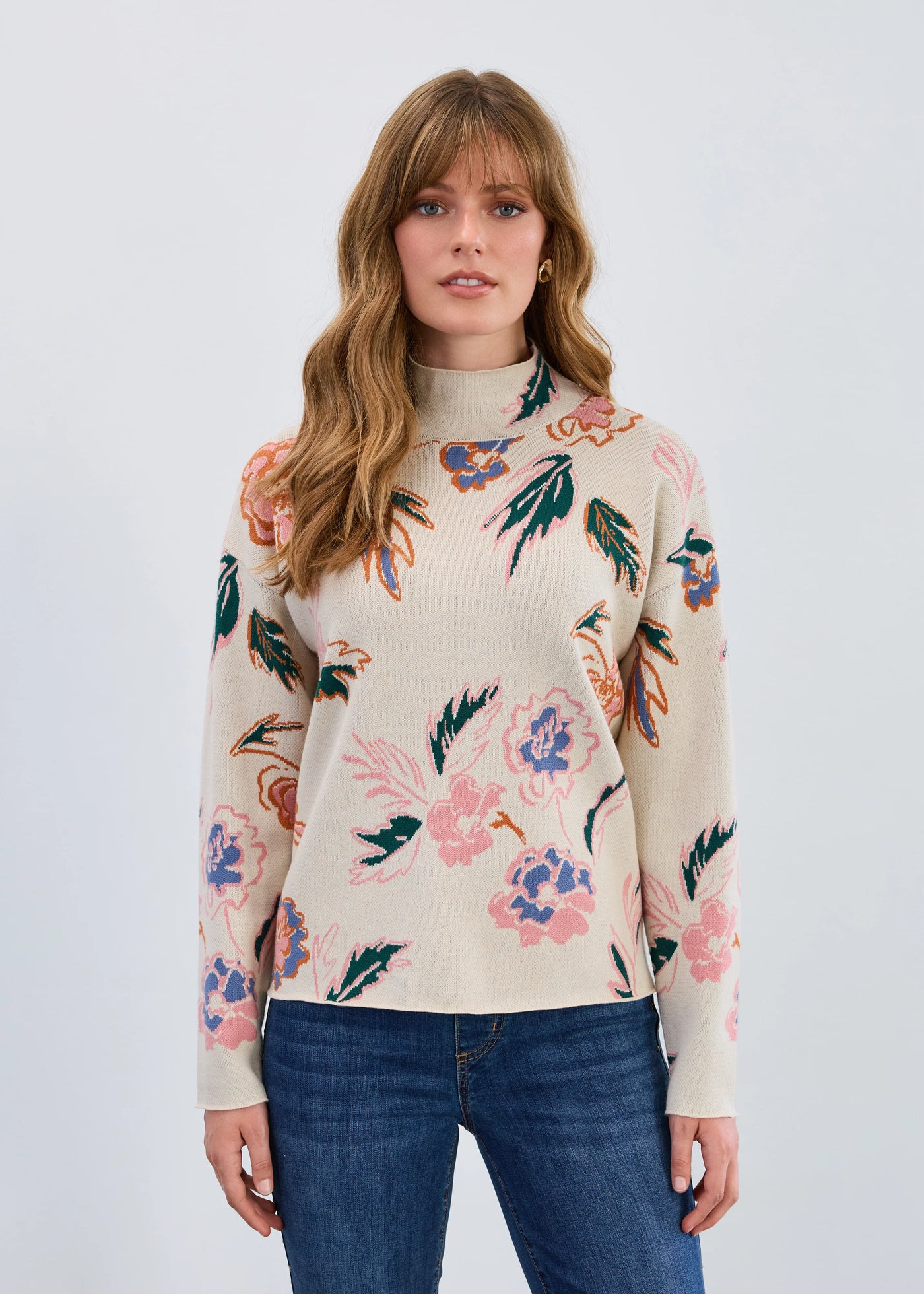 Woman wearing a floral patterned sweater against a plain background