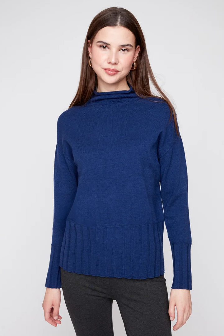 Woman wearing a blue sweater against a white background