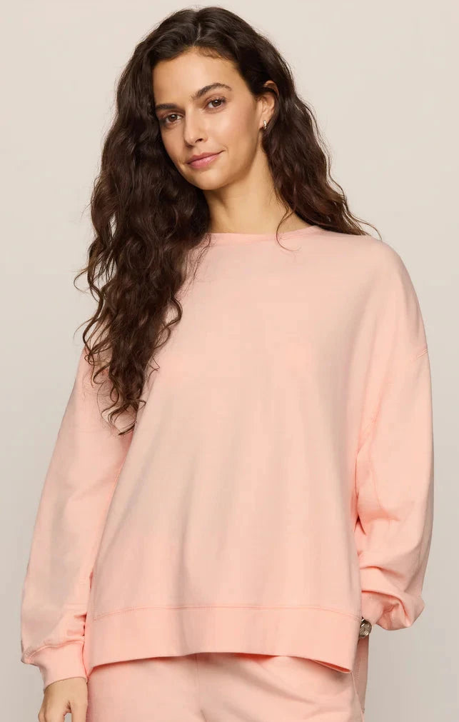 Woman wearing a pink outfit on a plain background