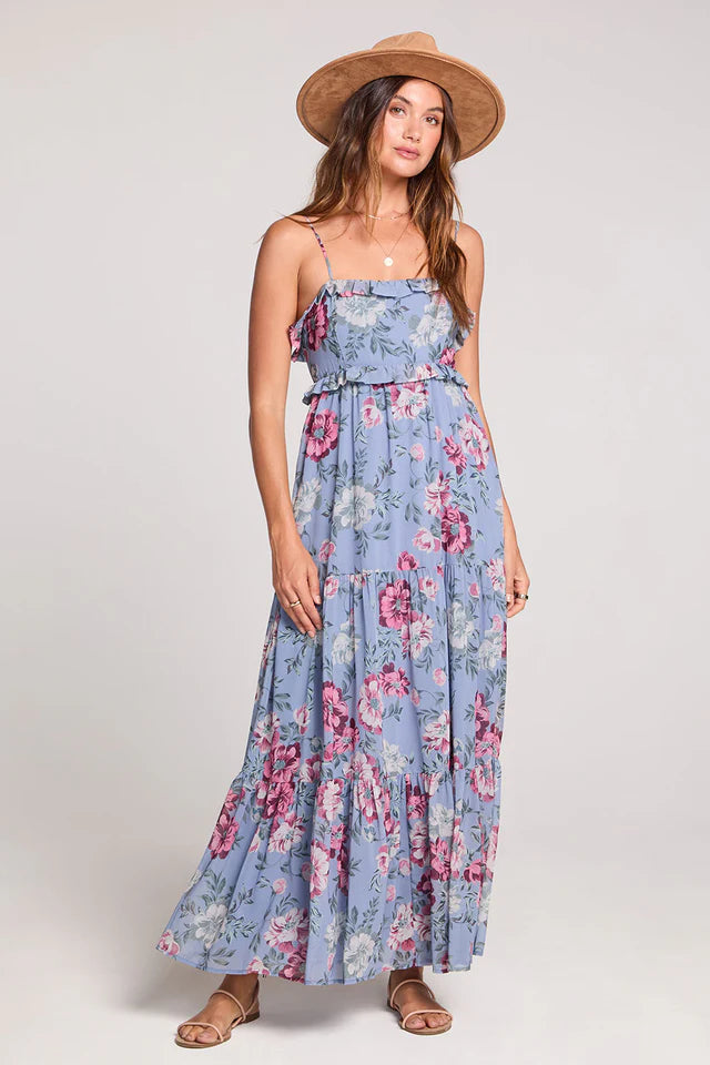 Woman wearing a blue floral dress with a white background