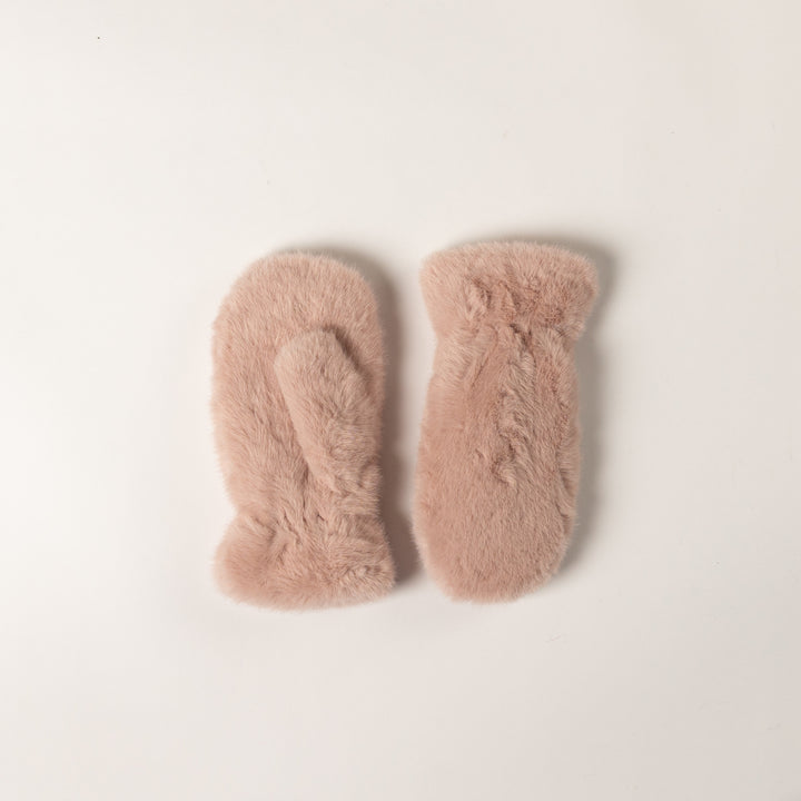 Pair of pink fuzzy socks on a light beige background