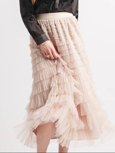 A model wearing a black long-sleeve blouse and a tiered light beige tulle midi skirt, shown against a plain white background with product text 'PS-17902 Stone' and price '$49.00' in the corners.