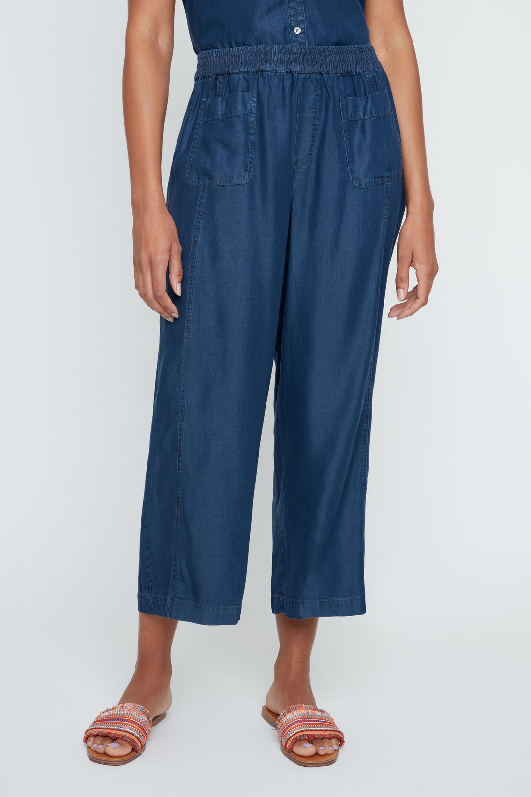 Person wearing a blue jumpsuit on a white background
