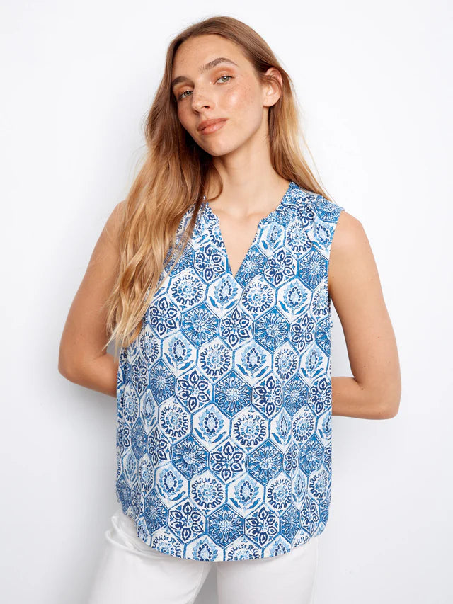 Woman wearing a blue patterned sleeveless top on a white background