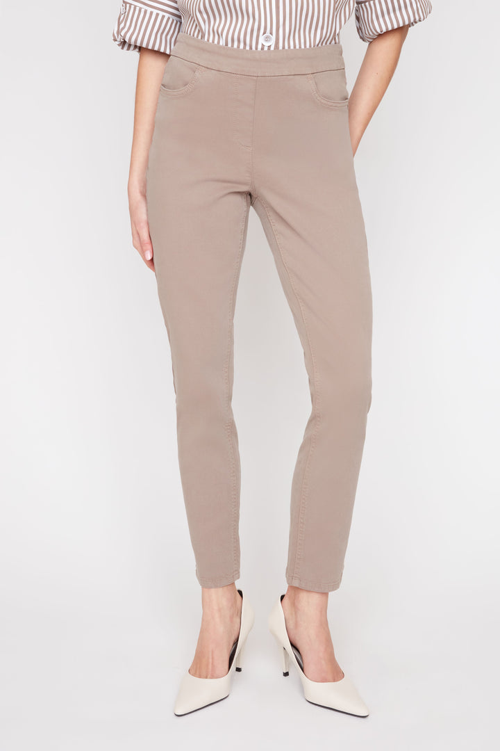 Beige pants worn by a person on a white background