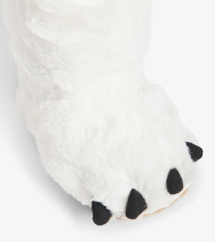 Close-up of a white paw with black pads on a light gray background