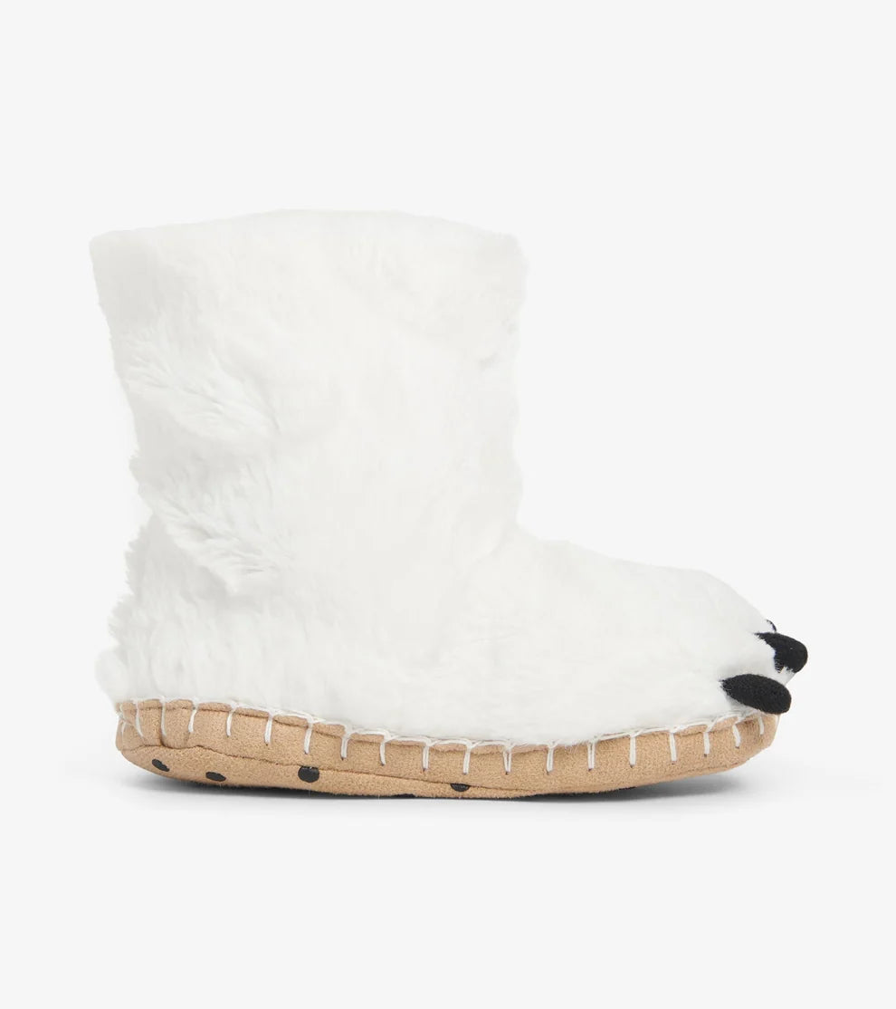 White fluffy slippers with a brown sole on a white background