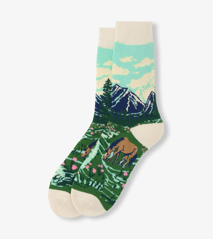 Sock with nature-themed design featuring mountains and animals on a white background