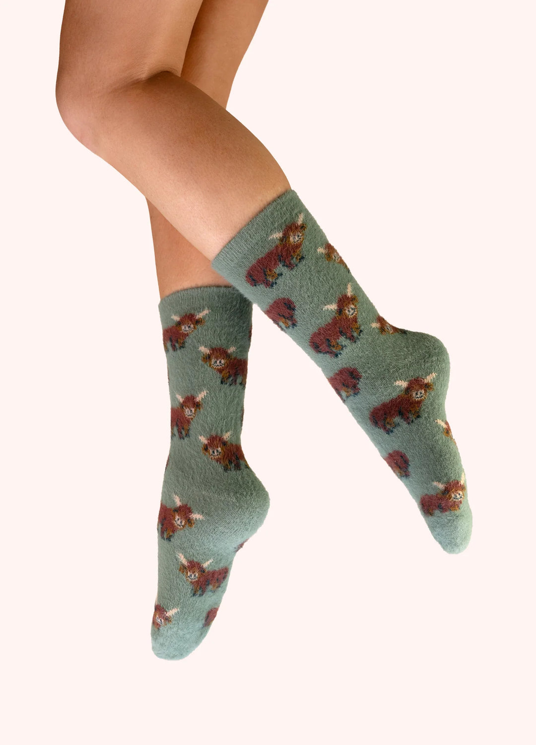 Green socks with bear pattern worn by a person on a white background