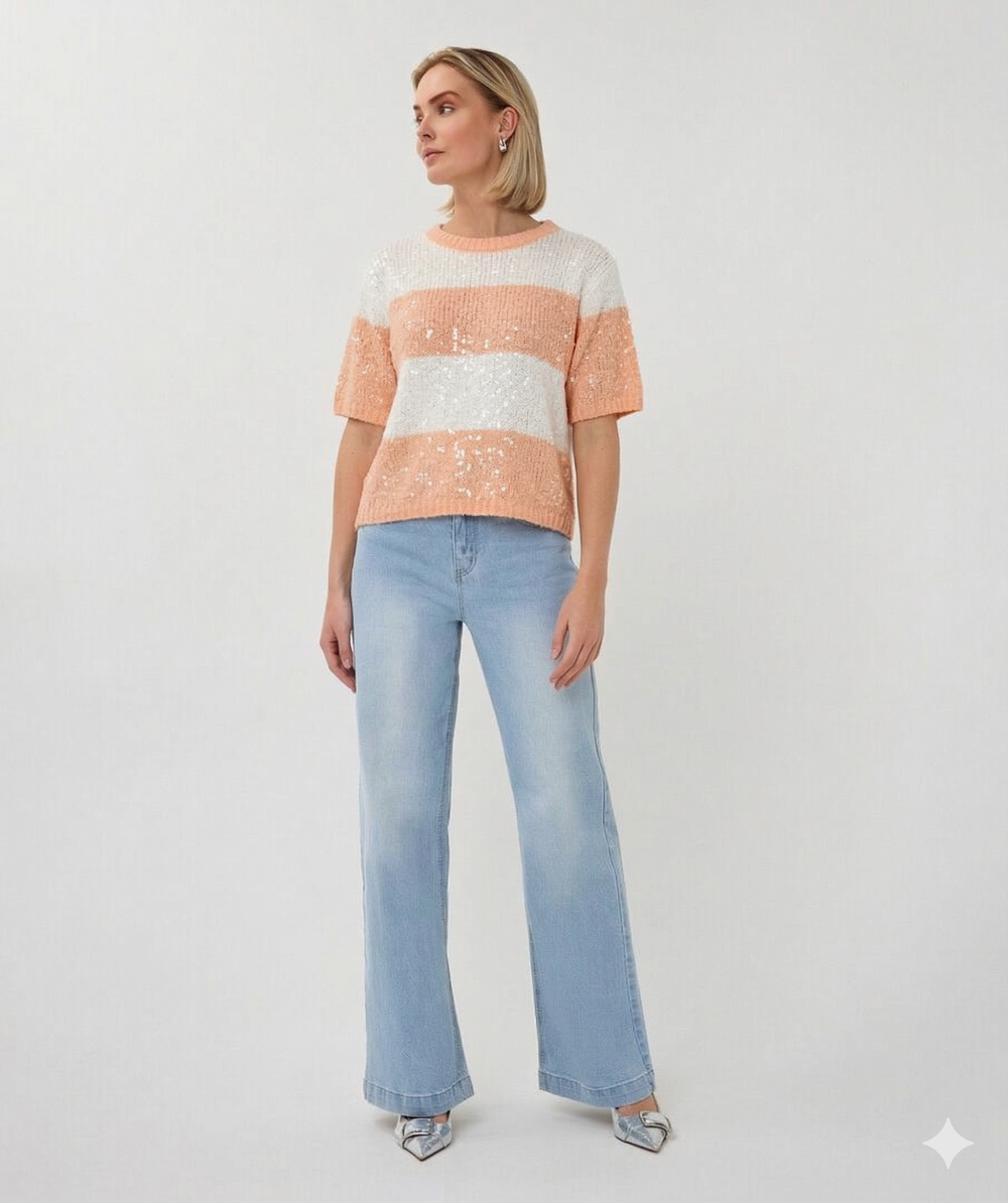 Woman wearing a striped sweater and light blue jeans on a white background