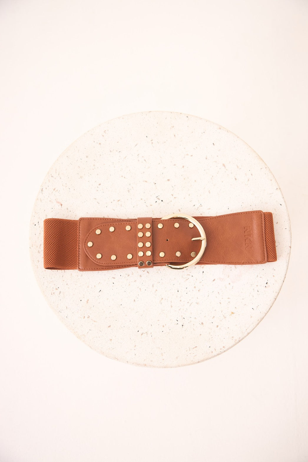 Brown belt with gold studs on a white background