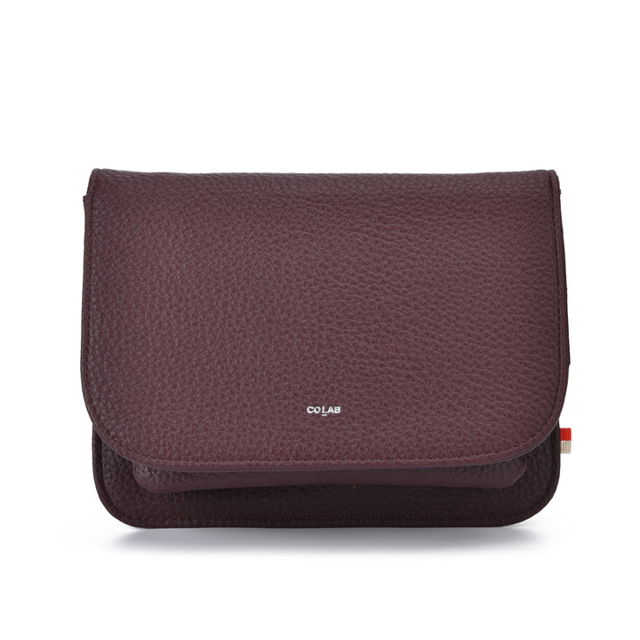 A dark burgundy pebbled leather pouch with a small silver &