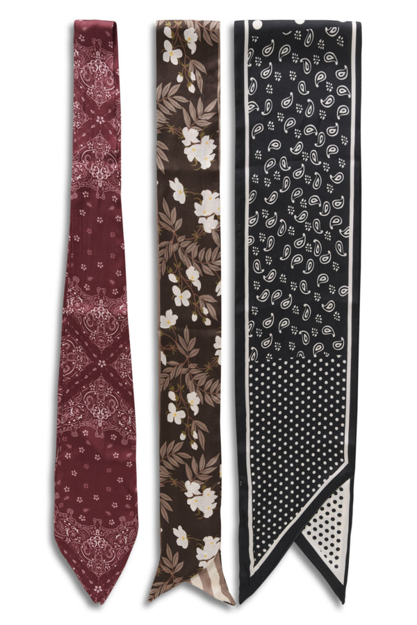 Three men's neckties with distinct patterns are displayed side-by-side against a plain white background. The left tie is burgundy with a white paisley pattern.
